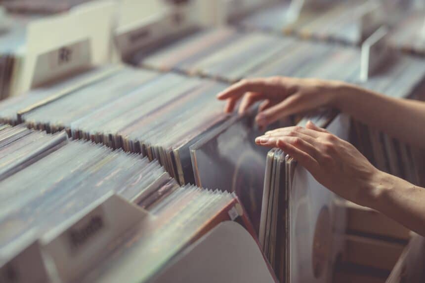 Women's hands browsing records in a vinyl record store