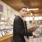 Young man browsing vinyl records in music store